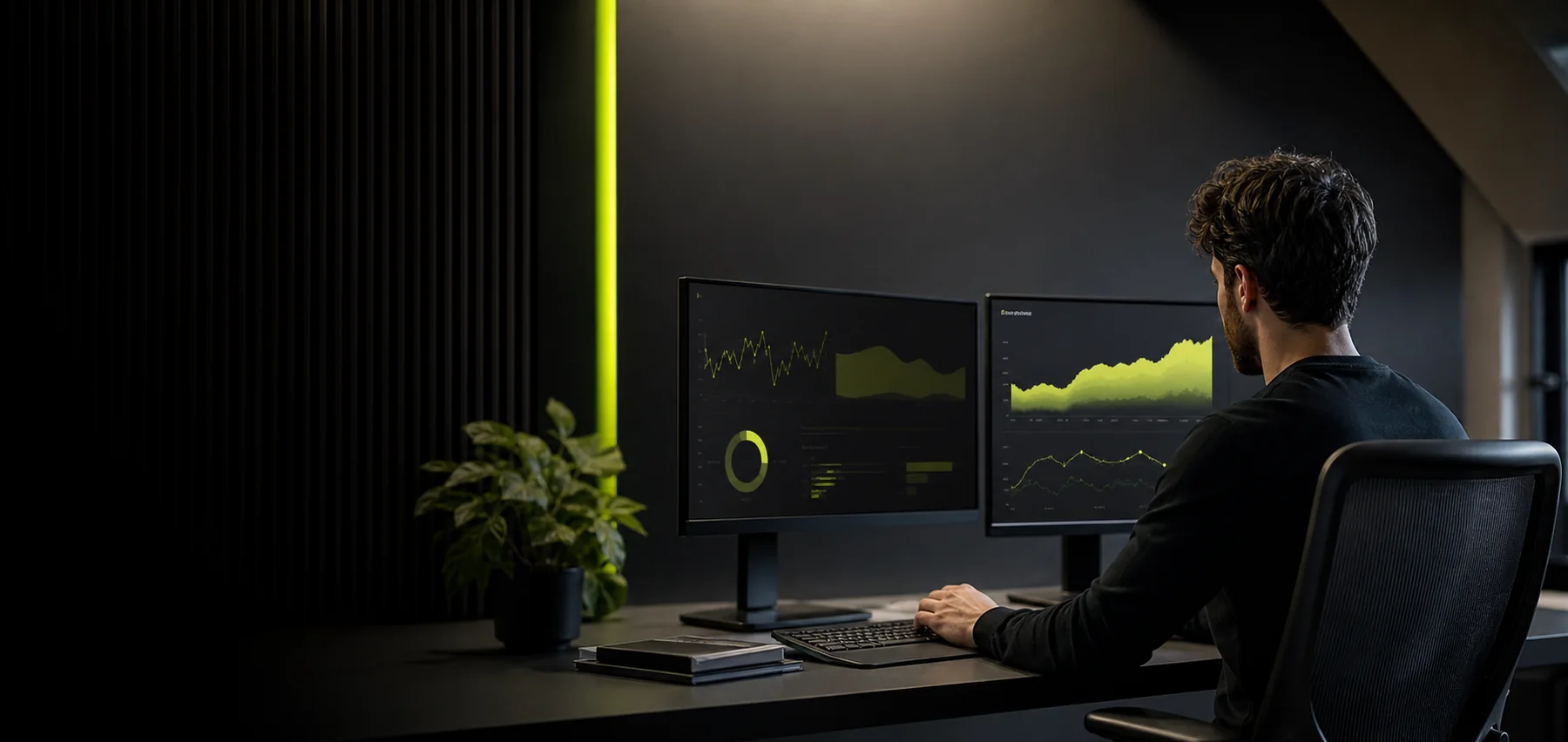 SEO strategist reviewing organic search performance on two monitors in a dark studio